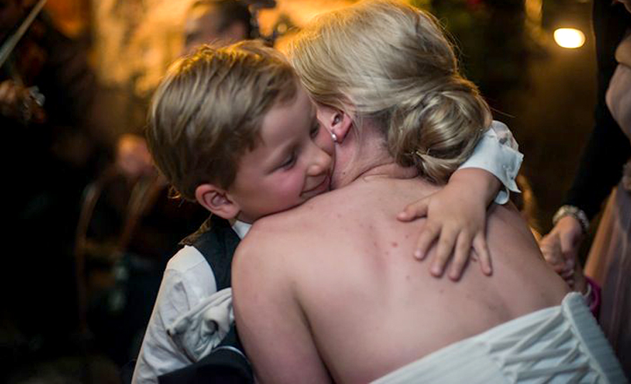 Adults Only Wedding - Little Boy Hugging A Bride